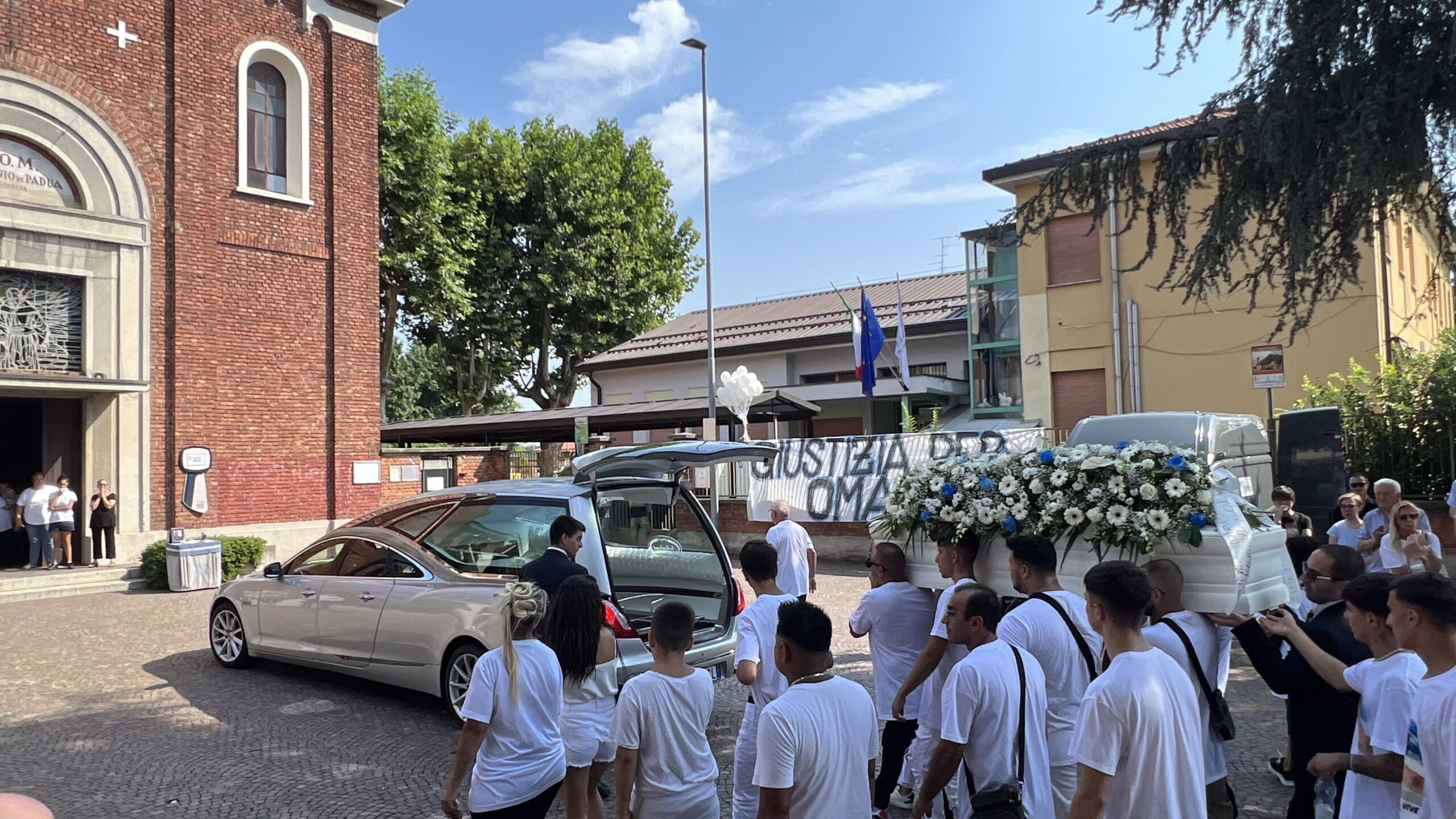 adn24 bollate mi | ai funerali di omar bassi uno striscione chiede giustizia